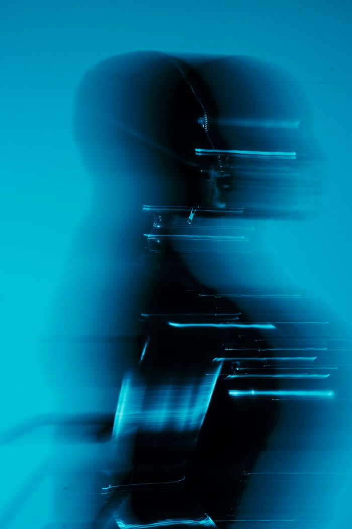 A dynamic abstract silhouette with a futuristic feel in cool blue lighting.